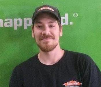 SERVPRO Employee Josh in front of a green work vehicle.